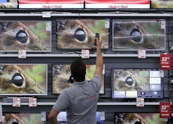 Employees of German electronics retailer Media-Saturn switch on television in their European state-of-the-art store in Ingolstadt, southern Germany, September 18, 2014. The shop will open in Ingolstadt on September 23.     REUTERS/Michaela Rehle (GERMANY - Tags: BUSINESS) - RTR46QP4