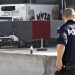 A police officer walks by a truck discovered abandoned on an Austrian motorway containing more than 70 bodies as it sits at a customs building with refrigeration facilities in the village of Nickelsdorf, Austria, August 28, 2015. The abandoned refrigerated lorry was found by an Austrian motorway patrol near the Hungarian border, with fluids from the decomposing bodies seeping from its back door. REUTERS/Heinz-Peter Bader - RTX1PZP3