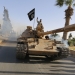 Militant Islamist fighters on a tank take part in a military parade along the streets of northern Raqqa province June 30, 2014. Militant Islamist fighters held a parade in Syria's northern Raqqa province to celebrate their declaration of an Islamic "caliphate" after the group captured territory in neighbouring Iraq, a monitoring service said. The Islamic State, an al Qaeda offshoot previously known as Islamic State in Iraq and the Levant (ISIL), posted pictures online on Sunday of people waving black flags from cars and holding guns in the air, the SITE monitoring service said.  REUTERS/Stringer (SYRIA - Tags: POLITICS CIVIL UNREST CONFLICT) - RTR3WJA0