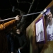 Javier Iglesias, father of Podemos (We Can) party leader Pablo Iglesias, puts up a poster of his son at the start of campaigning for Spain's general election in the village of Villaralbo, Spain, December 3, 2015.  REUTERS/Juan Medina - RTX1X3CU