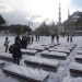 Tourists take a photo on the snow-covered Sultanahmet Square in the historic old town of Istanbul, Turkey,  December 31, 2015.  REUTERS/Osman Orsal - RTX20MLP