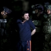 Joaquin "El Chapo" Guzman is escorted by soldiers during a presentation at the hangar belonging to the office of the Attorney General in Mexico City, Mexico January 8, 2016.  REUTERS/Edgard Garrido      TPX IMAGES OF THE DAY      - RTX21LRW