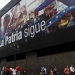 People walk past a billboard depicting Venezuela's President Nicolas Maduro and Venezuela's late President Hugo Chavez and the words "The country continues" in Caracas December 10, 2015. REUTERS/Christian Veron - RTX1Y5T5