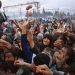 Migrants try to get products from a truck at a makeshift camp on the Greek-Macedonian border near the village of Idomeni, Greece March 10, 2016.    REUTERS/Stoyan Nenov TPX IMAGES OF THE DAY - RTSA7VY