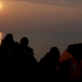 Refugees are silhouetted as they reach the shores of the Greek island of Lesbos on a dinghy during sunrise, March 20, 2016. REUTERS/Alkis Konstantinidis - RTSBA5L