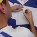 Venezuelan opposition leader and Governor of Miranda state Henrique Capriles fills a form during a signature drive seeking a referendum to remove President Nicolas Maduro in Caracas, Venezuela, April 27, 2016. REUTERS/Marco Bello   - RTX2BXPF