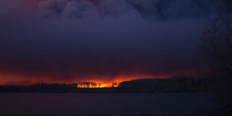 A massive wildfire, which caused a mandatory evacuation, rages south of Fort McMurray near Anzac, Alberta, Canada May 4, 2016. .  Chris Schwarz/Government of Alberta/Handout via REUTERS  ATTENTION EDITORS - THIS IMAGE WAS PROVIDED BY A THIRD PARTY. EDITORIAL USE ONLY. FOR EDITORIAL USE ONLY. NOT FOR SALE FOR MARKETING OR ADVERTISING CAMPAIGNS. THIS IMAGE HAS BEEN SUPPLIED BY A THIRD PARTY. IT IS DISTRIBUTED, EXACTLY AS RECEIVED BY REUTERS, AS A SERVICE TO CLIENTS - RTX2D1PL