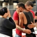 Friends and family members embrace outside the Orlando Police Headquarters during the investigation of a shooting at the Pulse night club, where as many as 20 people have been injured after a gunman opened fire, in Orlando, Florida, U.S June 12, 2016.  REUTERS/Steve Nesius     TPX IMAGES OF THE DAY      - RTX2FRIO