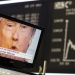 A TV screen showing U.S. President-elect Donald Trump is pictured in front of the German share price index, DAX board, at the stock exchange in Frankfurt, Germany, November 9, 2016. REUTERS/Staff/Remote - RTX2SQVH