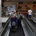 Angel Gomez Gamallo, 79, and his wife Luisa Fernandez Medarde, 81, leave a supermarket with a box full of food destined for one of their four children in Madrid April 29, 2014. When they retired a decade ago, Gomez and his wife had imagined spending their 3,600 euros in joint pension payments only on restaurants, holidays and toys for the grandkids. Today, their retirement money also helps support five families. The Spanish couple, like other relatively prosperous pensioners across southern Europe, are providing an informal safety net which has helped many in the younger generation to avoid widespread poverty despite record-high unemployment. Picture taken April 29, 2014. To match Insight story EUROPE-SOUTH/PENSIONS        REUTERS/Susana Vera (SPAIN - Tags: BUSINESS EMPLOYMENT POLITICS SOCIETY) - RTR3R5MA
