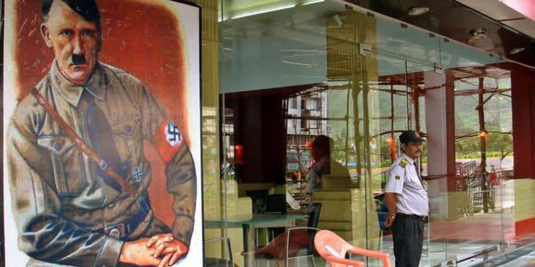 A security personnel stands guard outside a new restaurant, named after Adolf Hitler and promoted with posters showing the German leader and Nazi swastikas, on the outskirts of Mumbai August 21, 2006. The new restaurant in India's financial hub has infuriated the country's small Jewish community. REUTERS/Stringer (INDIA) - RTR1GKID