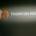A man polishes a new logo of Thomson Reuters at the Reuters head offices at Canary Wharf in London April 16, 2008.