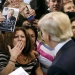 A woman blows a kiss to Republican presidential candidate Donald Trump (R) after Trump autographed her chest at his campaign rally in Manassas, Virginia December 2, 2015.  Republican presidential front-runner Trump said on Wednesday his plan for combating Islamic State militants involves targeting not just the group's fighters but also their families.         REUTERS/Gary Cameron     - RTX1WXD4