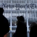 People stand across the street from the New York Times head office in New York, in this February 7, 2013, file photo.   REUTERS/Carlo Allegri/Files