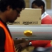 A worker packs boxes at Amazon's logistics centre in Graben near Augsburg December 17, 2012. REUTERS/Michael Dalder