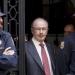 Former International Monetary Fund chief Rodrigo Rato (C) walks between police officers as he leaves his office in Madrid April 17, 2015.   REUTERS/Andrea Comas