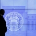 A security guard walks in front of an image of the Federal Reserve following the two-day Federal Open Market Committee (FOMC) policy meeting in Washington, March 16, 2016.  REUTERS/Kevin Lamarque/File Photo