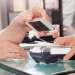 Female customer paying with mobilephone using NFC in hair salon