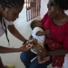 A young girl receives a vaccine injection during vaccinations at Mahulana Health Center, Moamba District, Maputo Province, Mozambique (2017).