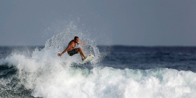 A man surfs in the Mediterranean Sea as seen from a beach in Ashkelon, Israel June 21, 2017. REUTERS/Amir Cohen