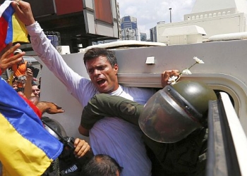 Venezuelan opposition leader Leopoldo Lopez gets into a National Guard armored vehicle in Caracas February 18, 2014. Lopez, wanted on charges of fomenting deadly violence, handed himself over to security forces on Tuesday, Reuters witnesses said. Lopez, a 42-year-old U.S.-educated economist who has spearheaded a recent wave of protests in Venezuela, got into an armored vehicle after giving a speech to an opposition rally in Caracas. REUTERS/Jorge Silva (VENEZUELA - Tags: POLITICS CIVIL UNREST TPX IMAGES OF THE DAY)