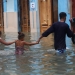 A man and two children wade through a flooded street,  after the passing of Hurricane Irma, in Havana, Cuba September 10, 2017. REUTERS/Stringer