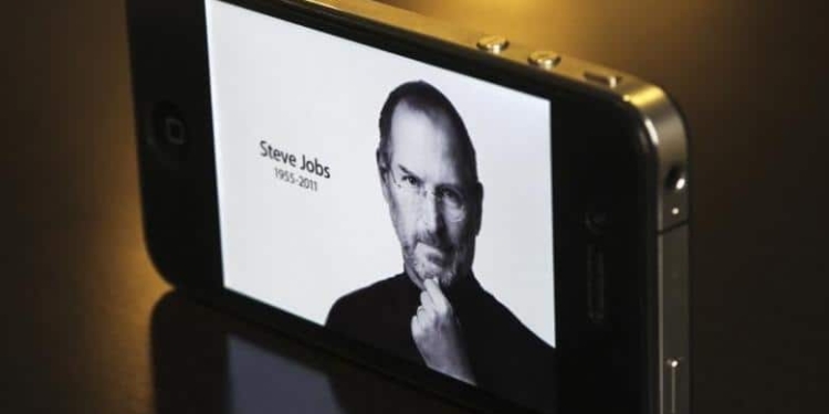 The main Apple Inc website featuring Apple co-founder Steve Jobs is seen on an iPhone in this photo illustration taken in Central Sydney October 6, 2011. REUTERS/Daniel Munoz