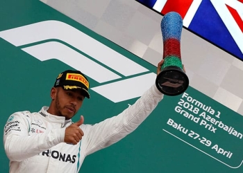 Formula One - F1 - Azerbaijan Grand Prix - Baku City Circuit, Baku, Azerbaijan - April 29, 2018   Mercedes' Lewis Hamilton celebrates with a trophy on the podium after winning the race   REUTERS/David Mdzinarishvili