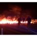 Agentes de policía junto a barricadas en llamas que intentaron bloquear la autopista AP7 durante una huelga general cerca de Girona.