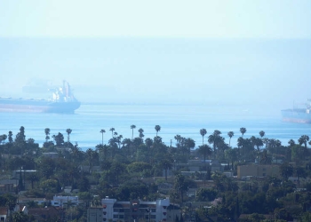 An oil tanker and a container ship sit off shore of the port of the Long Beach during the outbreak of the coronavirus disease (COVID-19) in Long Beach, California, U.S., April 23, 2020. RE