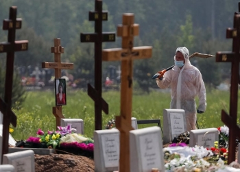 Un sepulturero con equipo de protección personal camina después de enterrar a una persona, que presumiblemente murió de la enfermedad por coronavirus (COVID-19) en un cementerio en las afueras de San Petersburgo, Rusia, 10 de junio de 2020. REUTERS / Anton Vaganov