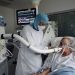 Christian George, Director of Research at the National Centre of Scientific Research, helps a patient suffering from coronavirus disease (COVID-19) to use the COVID-19 'Breathalyzer' test machine  at the La Croix-Rousse Hospital in Lyon, France, July 22, 2020. Picture taken July 22, 2020. REUTERS/Yiming Woo  NO RESALES. NO ARCHIVES